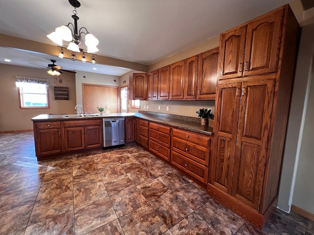 kitchen featuring kitchen peninsula, ceiling fan with notable chandelier, sink, dishwasher, and hanging light fixtures