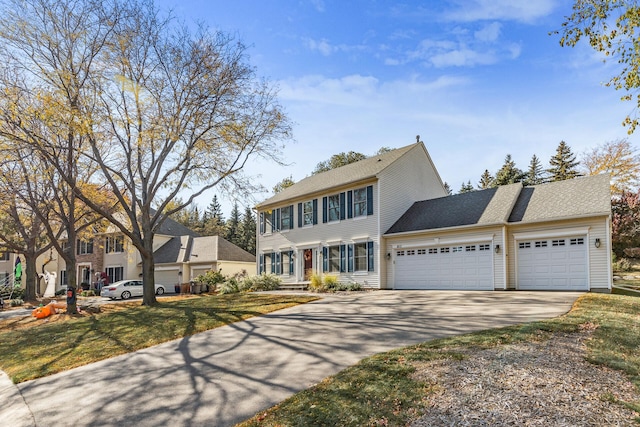 colonial house with an attached garage and driveway