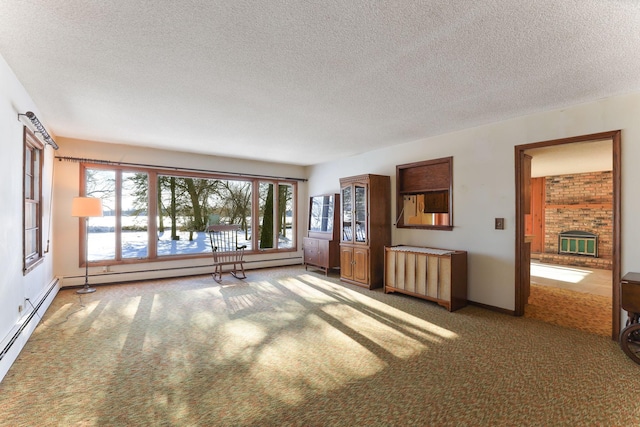 empty room with a brick fireplace, plenty of natural light, and dark carpet