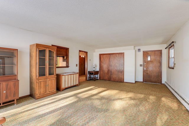 unfurnished living room featuring light carpet, baseboard heating, and a textured ceiling