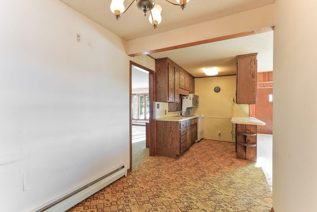 kitchen with a notable chandelier, a textured ceiling, electric range, and a baseboard radiator