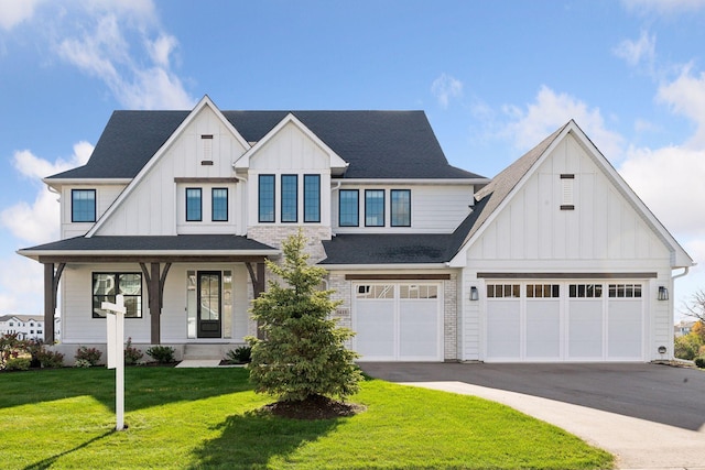 modern farmhouse style home with a front lawn and a garage