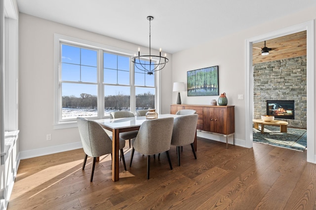 dining area featuring plenty of natural light, baseboards, wood finished floors, and a notable chandelier