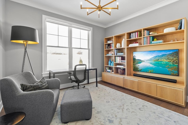 interior space featuring baseboards, a chandelier, ornamental molding, and wood finished floors