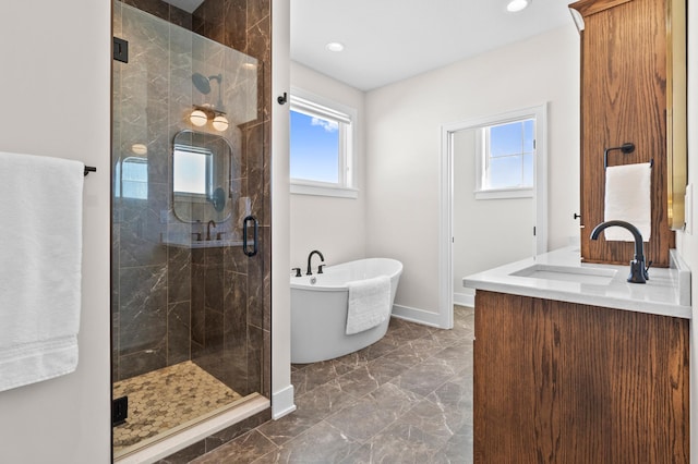 full bathroom with a freestanding tub, a shower stall, a wealth of natural light, and marble finish floor
