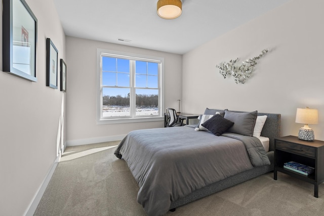 bedroom featuring baseboards, carpet flooring, and visible vents