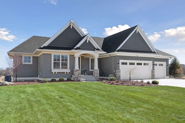 craftsman-style house with driveway, roof with shingles, a garage, a front lawn, and stone siding
