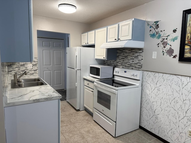 kitchen featuring tasteful backsplash, a textured ceiling, white cabinetry, sink, and white appliances