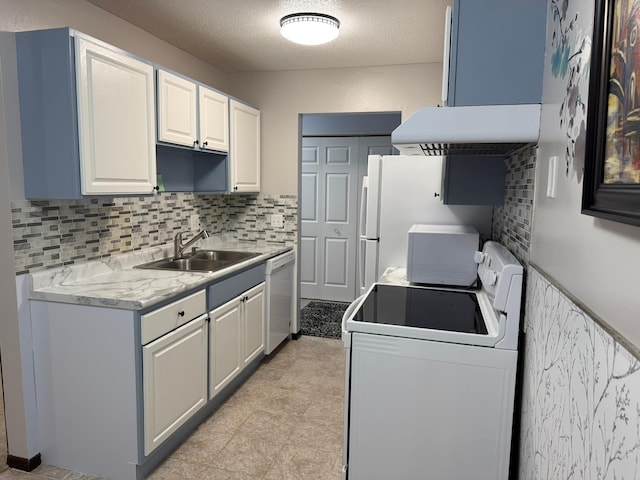 kitchen with decorative backsplash, a textured ceiling, white cabinetry, sink, and white appliances