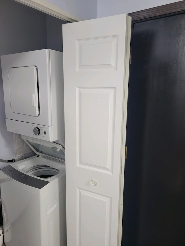 laundry area with stacked washer / dryer