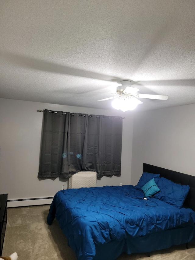 carpeted bedroom with a textured ceiling, baseboard heating, and ceiling fan