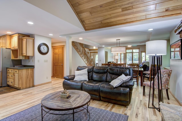 living room with lofted ceiling and light hardwood / wood-style floors