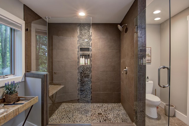 bathroom with walk in shower, toilet, and tile patterned floors