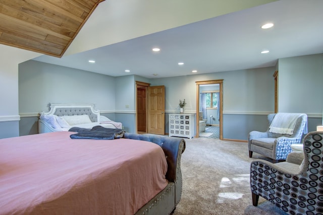 carpeted bedroom with lofted ceiling, wooden ceiling, and ensuite bath