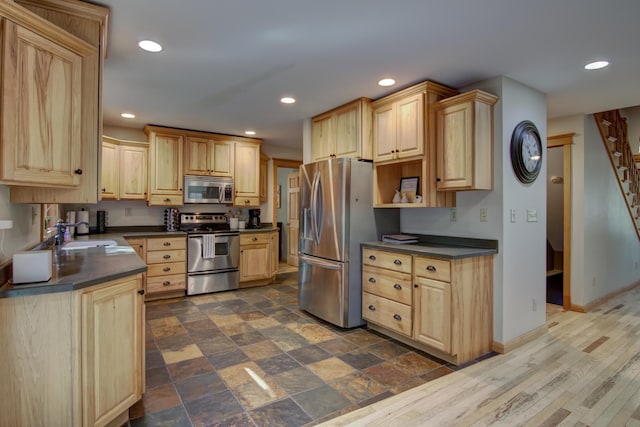 kitchen featuring light brown cabinetry, appliances with stainless steel finishes, dark hardwood / wood-style floors, and sink