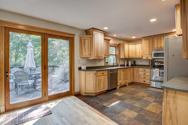 kitchen with sink, light brown cabinets, and stainless steel appliances