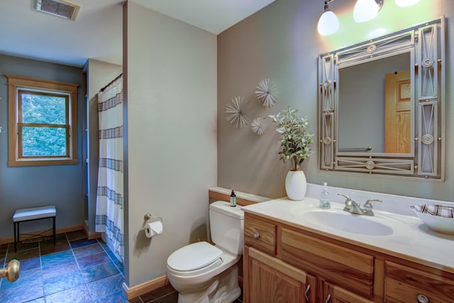 bathroom with toilet, vanity, and curtained shower