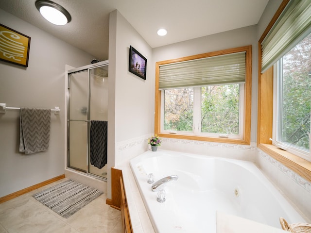 bathroom featuring a wealth of natural light, tile patterned floors, and shower with separate bathtub