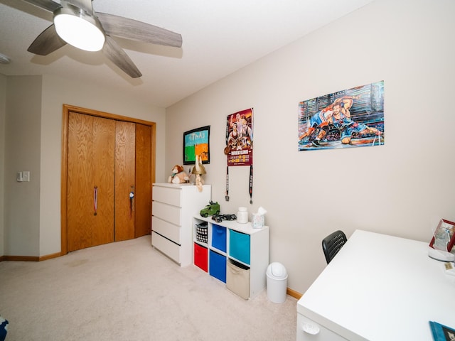 carpeted office space featuring ceiling fan