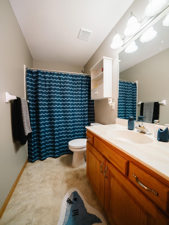 bathroom featuring vanity, a textured ceiling, toilet, and tile patterned floors