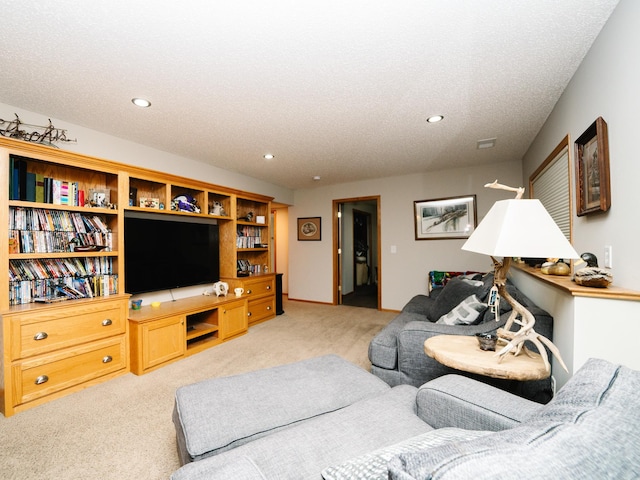 carpeted living room featuring a textured ceiling