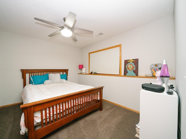 carpeted bedroom with a textured ceiling and ceiling fan