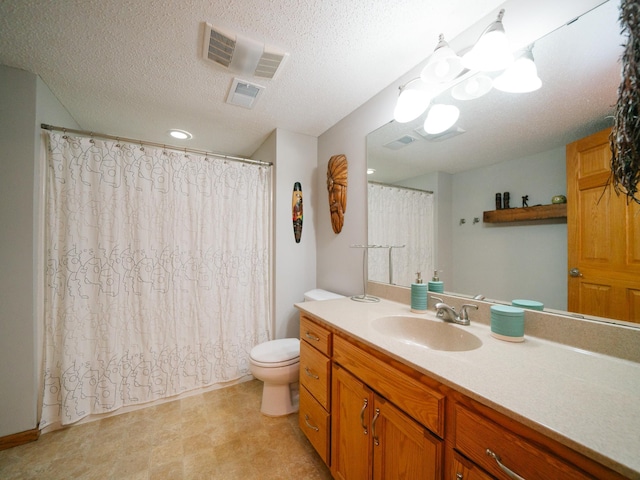 bathroom featuring vanity, a shower with shower curtain, a textured ceiling, and toilet