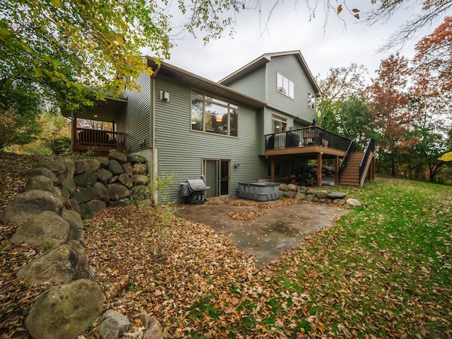 rear view of property with a patio area and a deck