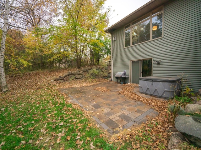 view of patio / terrace with a hot tub and a grill