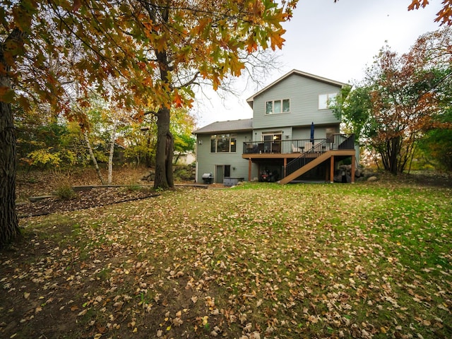 back of house with a deck