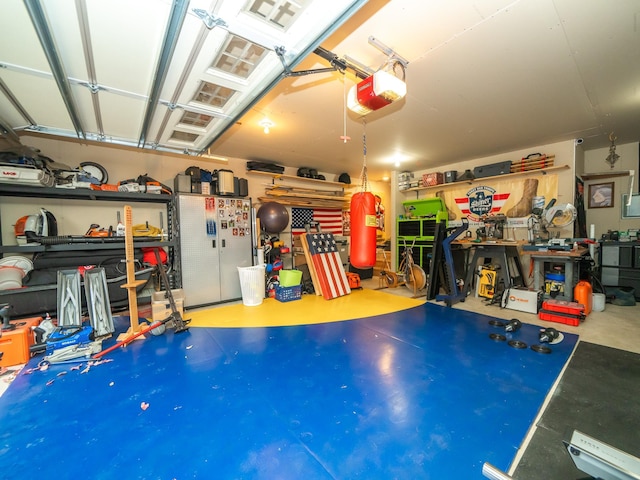 garage with a garage door opener and stainless steel refrigerator