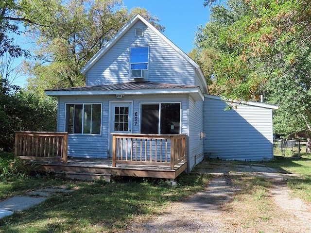 back of house featuring a lawn and a wooden deck