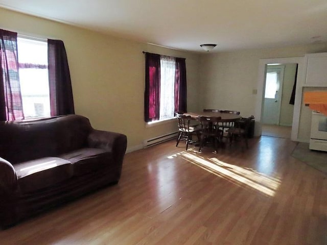 living room with baseboard heating and hardwood / wood-style flooring