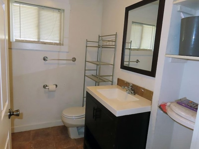 bathroom featuring tile patterned flooring, vanity, and toilet