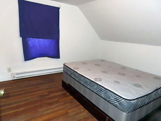 bedroom with lofted ceiling, a baseboard heating unit, and dark hardwood / wood-style flooring