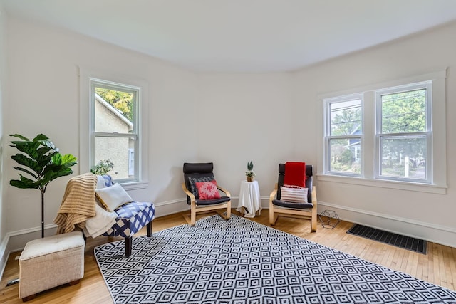 sitting room with hardwood / wood-style flooring