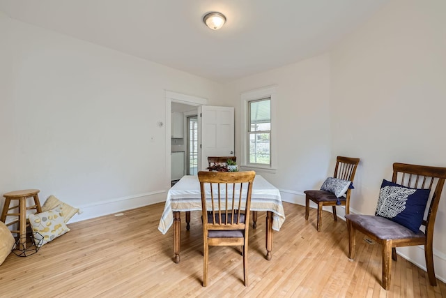 dining space with light hardwood / wood-style floors