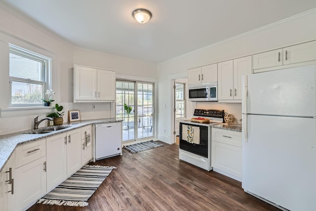 kitchen featuring white appliances, white cabinets, and plenty of natural light