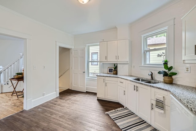 kitchen with white dishwasher, white cabinetry, sink, and dark hardwood / wood-style floors