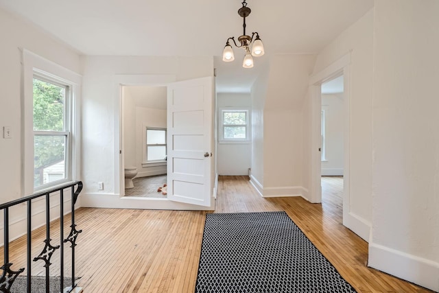 interior space featuring light wood-type flooring and a chandelier