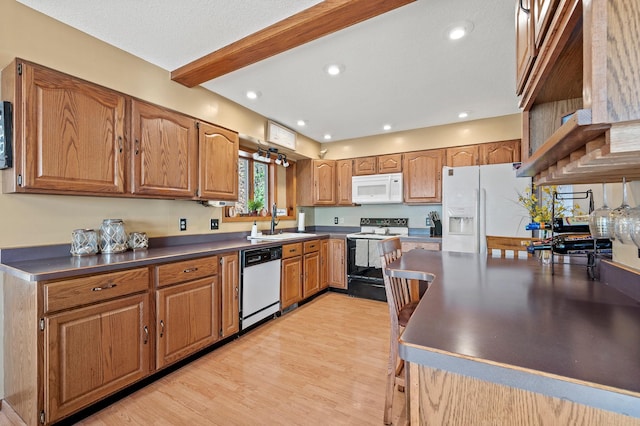 kitchen featuring beamed ceiling, sink, a textured ceiling, white appliances, and light wood-type flooring