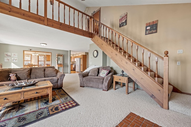 living room featuring carpet flooring and high vaulted ceiling