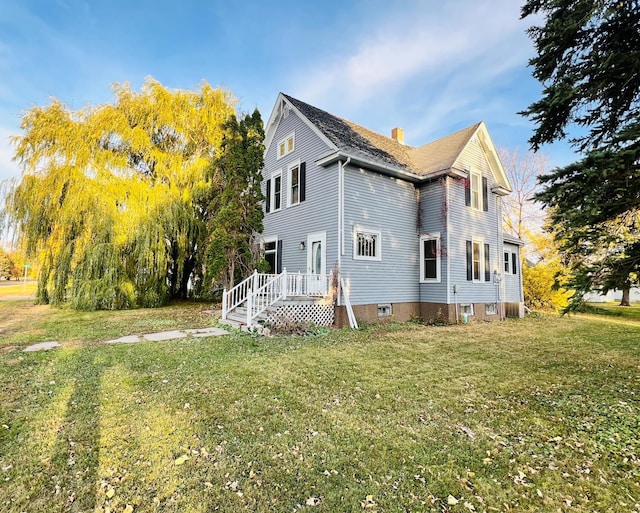 view of side of property with a yard