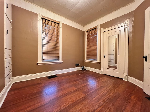 spare room with dark hardwood / wood-style flooring