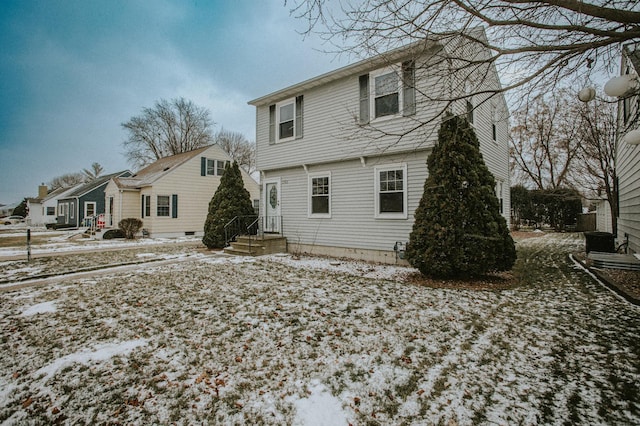 view of snow covered back of property