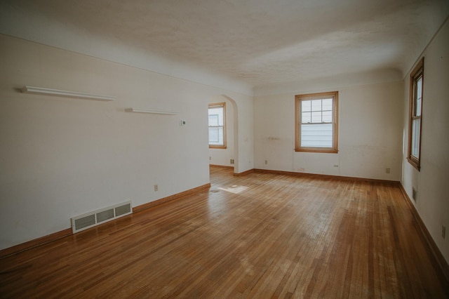 empty room with hardwood / wood-style flooring