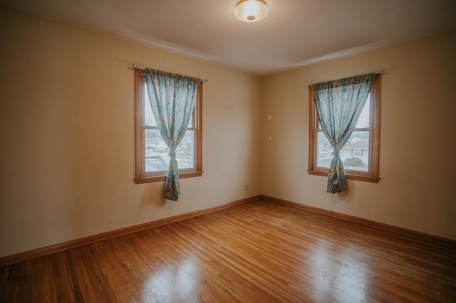 unfurnished room featuring hardwood / wood-style floors