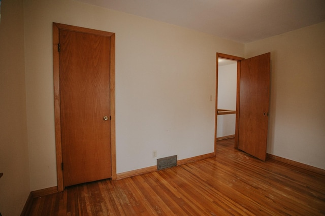 empty room featuring hardwood / wood-style flooring