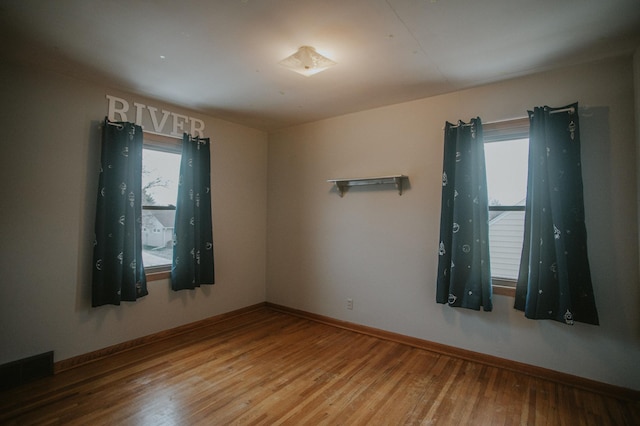 spare room with hardwood / wood-style flooring