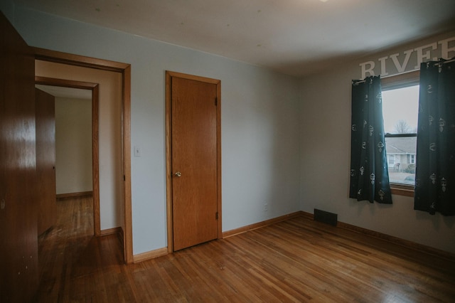 unfurnished room featuring hardwood / wood-style floors